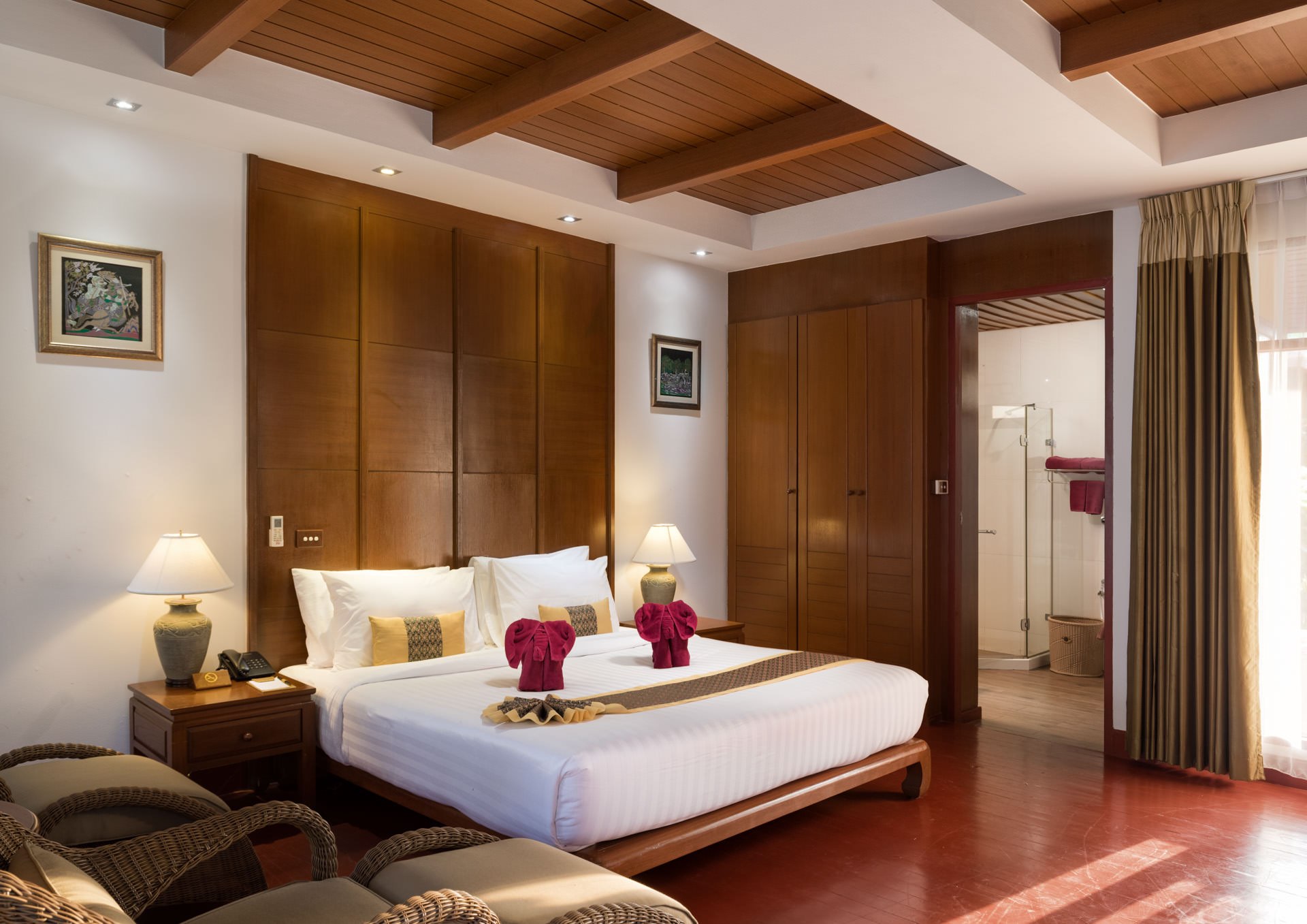 Cozy hotel room at Erawan Palms, featuring wooden paneling and a comfortable bed on Phi Phi Island.